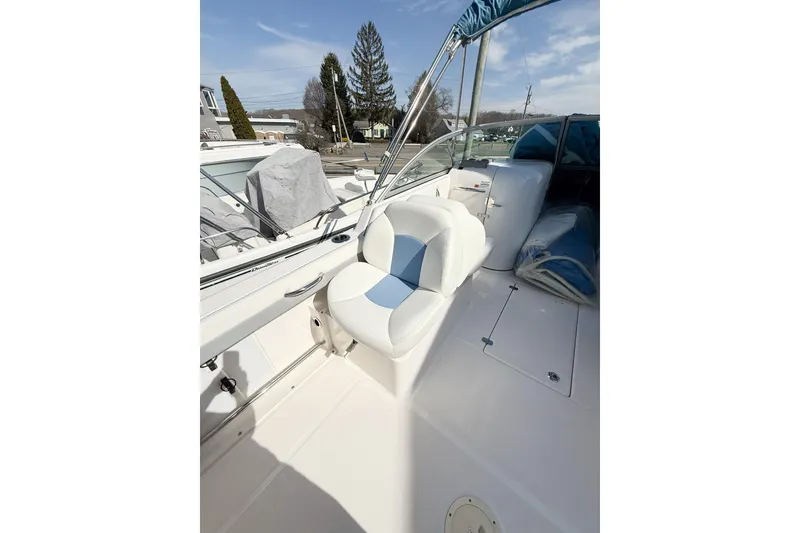 Slide: The Image of 2022 Robalo R227 Dual Console boat interior with white and blue seating. - 21