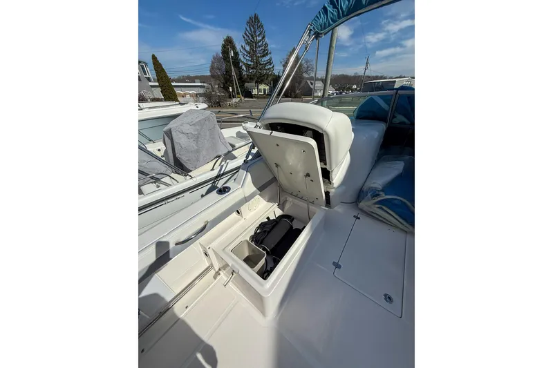 Slide: The Image of 2022 Robalo R227 Dual Console boat with open storage compartments. - 22