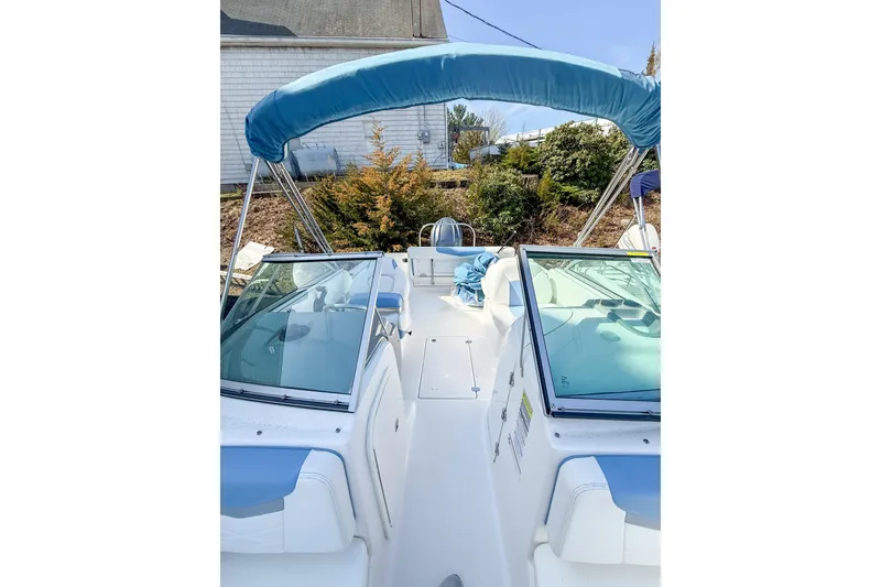 Slide: The Image of 2022 Robalo R227 Dual Console boat with blue canopy and seating. - 29