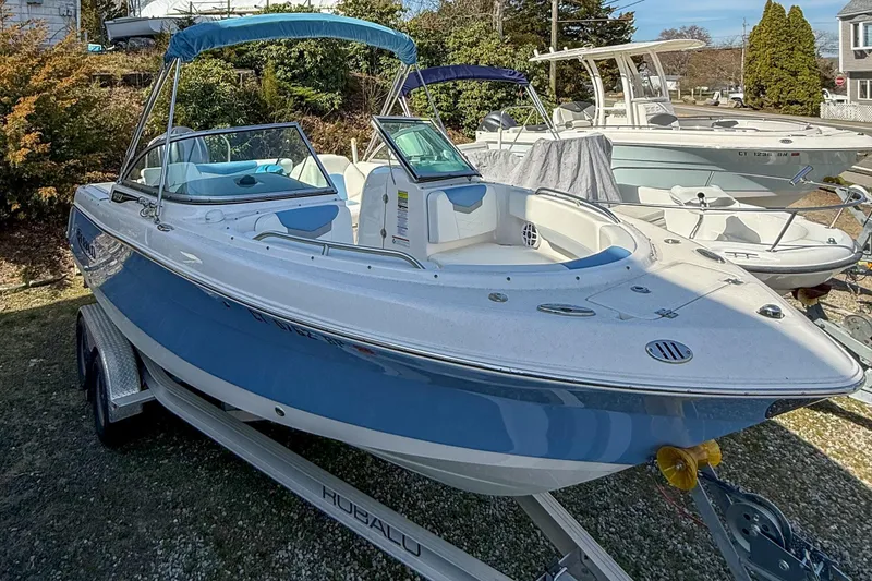 Slide: The Image of 2022 Robalo R227 Dual Console boat on trailer, blue and white exterior. - 3