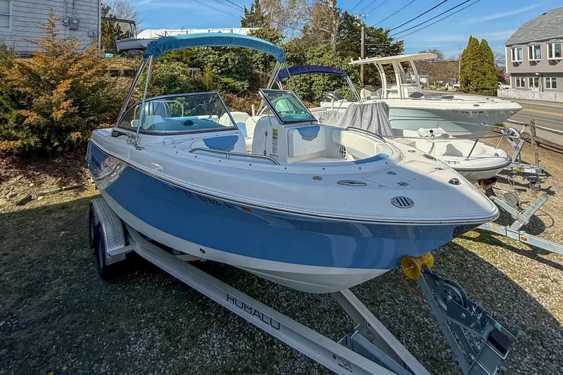 Slide: The Image of 2022 Robalo R227 Dual Console boat on trailer, blue and white exterior. - 5