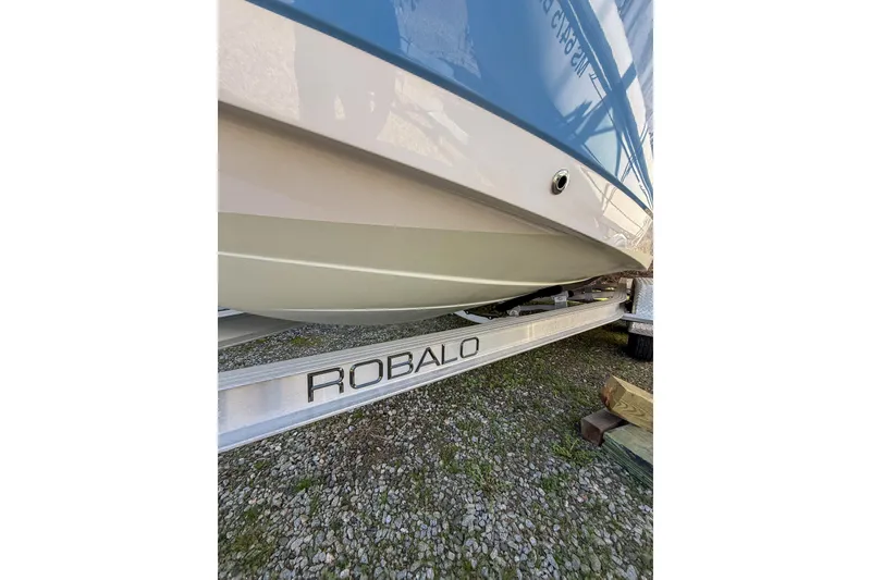 Slide: The Image of 2022 Robalo R227 Dual Console boat on trailer, side view. - 8