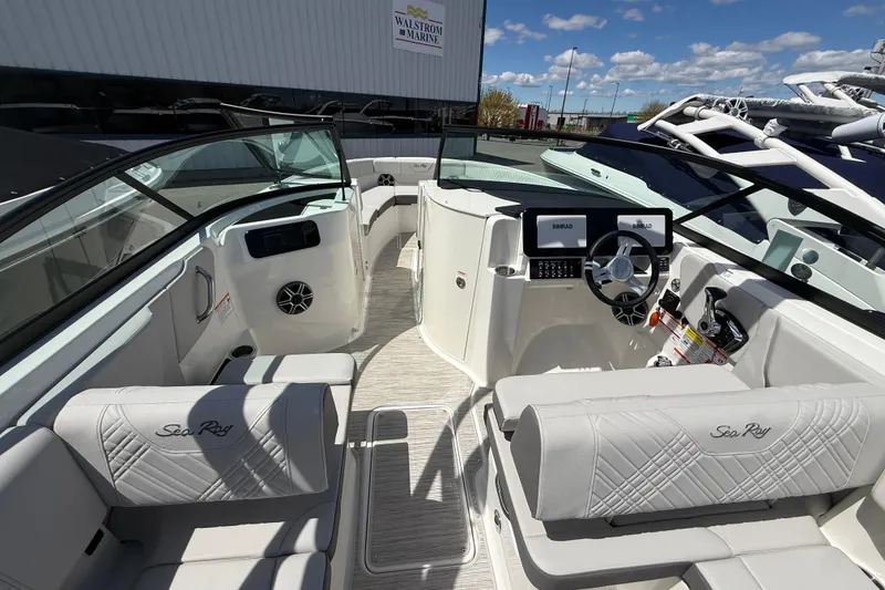 Slide: The Image of Interior of 2026 Sea Ray SDX 250 boat with modern dashboard and seating. - 10