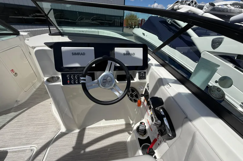 Slide: The Image of 2026 Sea Ray SDX 250 boat dashboard with Simrad displays and steering wheel. - 12