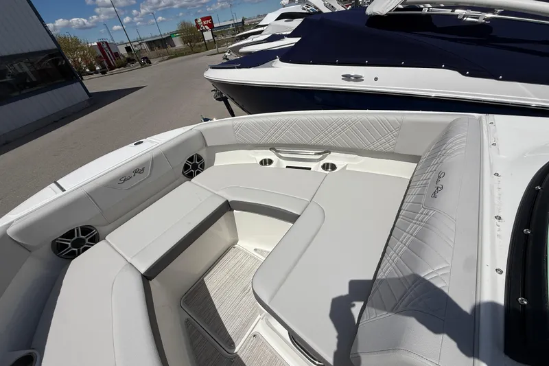 Slide: The Image of 2026 Sea Ray SDX 250 boat interior with white seating and cup holders. - 17