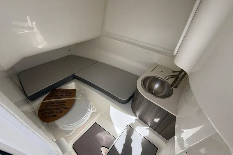 Slide: The Image of Interior of 2026 Sea Ray SDX 250 boat featuring a compact sink and seating area. - 19