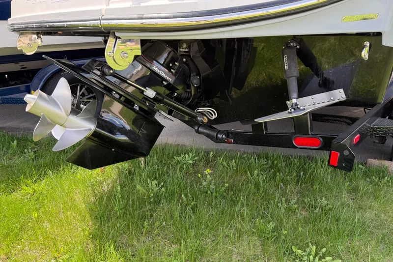 Slide: The Image of 2026 Sea Ray SDX 250 boat stern with Mercury MerCruiser engine and propeller on grass. - 20
