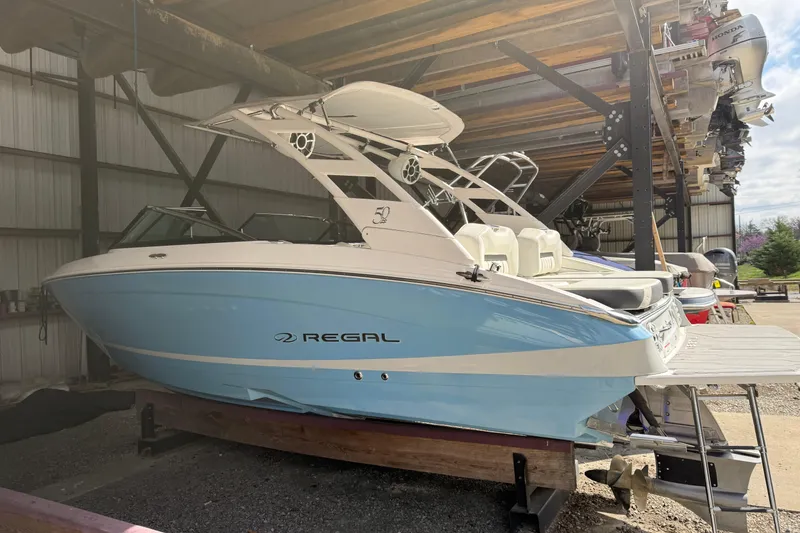 The Image of 2021 Regal LS4 Surf boat in storage, showcasing sleek design and modern features. - 0