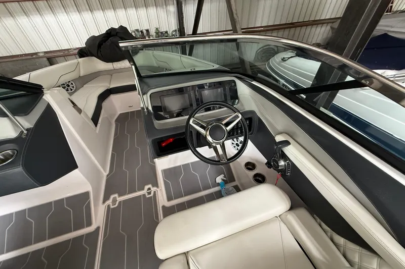 Slide: The Image of 2021 Regal LS4 Surf boat control panel with throttle and trim buttons. - 19