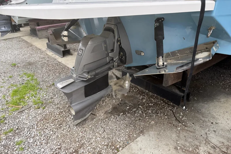 Slide: The Image of 2021 Regal LS4 Surf boat in light blue, displayed outdoors on a sunny day. - 2