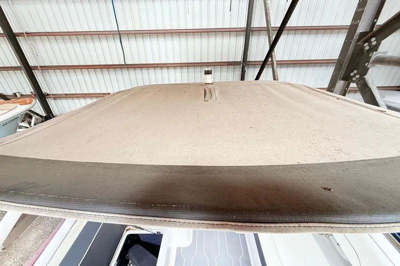 Slide: The Image of 2021 Regal LS4 Surf boat interior with seating and windshield in a storage facility. - 24