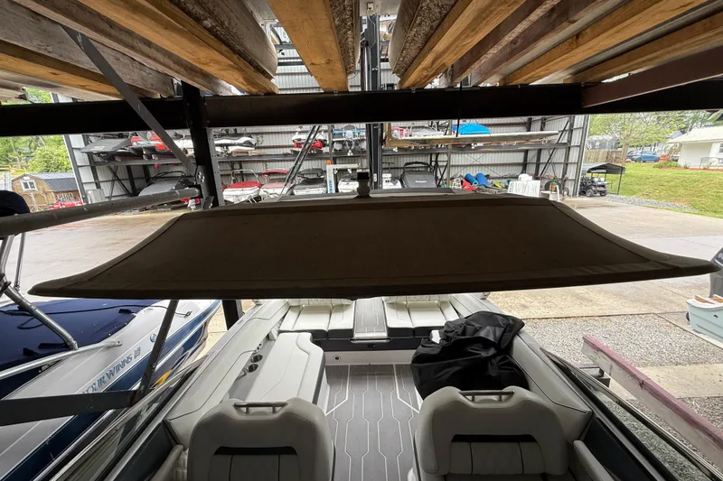 Slide: The Image of 2021 Regal LS4 Surf boat interior with cushioned seating and storage compartments. - 33
