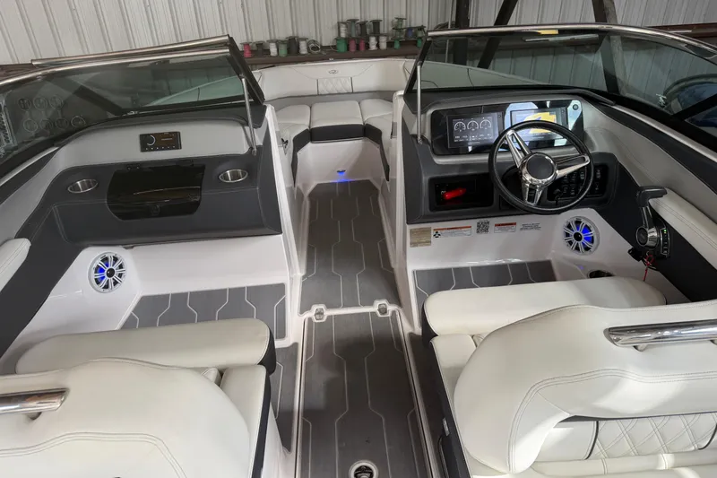 Slide: The Image of 2021 Regal LS4 Surf boat with a covered deck in a storage facility. - 34