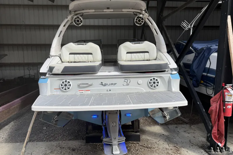 Slide: The Image of 2021 Regal LS4 Surf boat interior with sleek seating and modern dashboard design. - 5