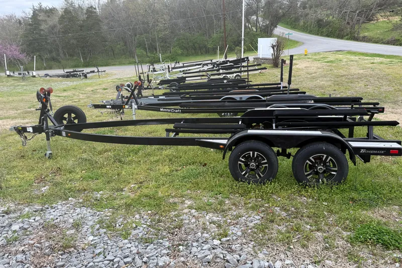 Slide: The Image of Boat trailers lined up on grassy area, showcasing MasterCraft and Boatmate brands. - 54