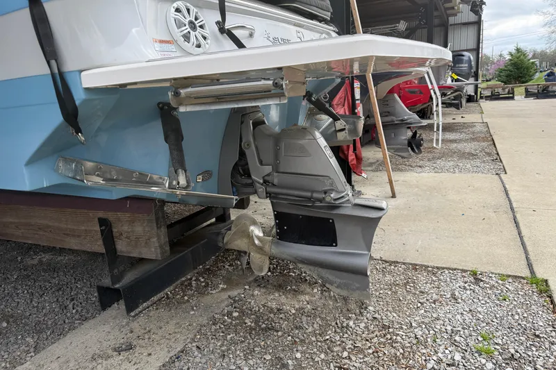 Slide: The Image of 2021 Regal LS4 Surf boat with canopy, docked near storage facility. - 6