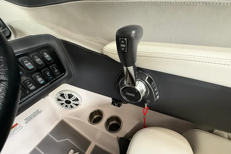 Slide: The Image of 2021 Regal LS4 Surf boat interior with canopy, docked near other boats. - 9