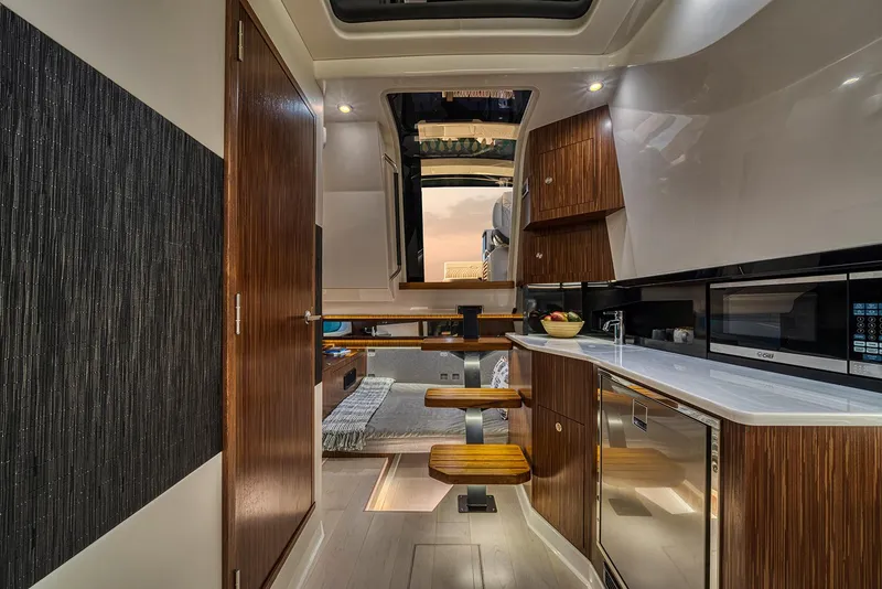 Slide: The Image of Manufacturer Provided Image: Luxurious seating on 2025 Sea Ray Sundancer 370 yacht, overlooking serene waters. - 12