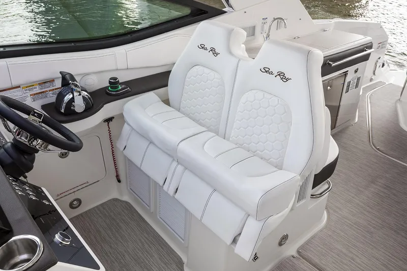 Slide: The Image of 2026 Sea Ray Sundancer 320 helm with dual white seats and modern controls. - 11
