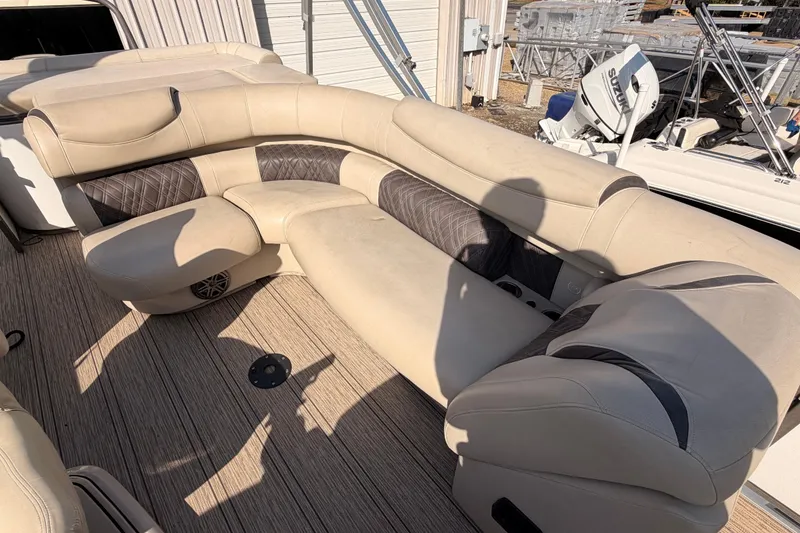 Slide: The Image of Luxurious seating on 2021 Premier 250 Grand Majestic boat, featuring beige upholstery and wood-textured flooring. - 9