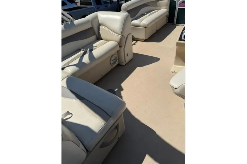 Slide: The Image of Interior of a 2015 Sweetwater 2086 BW boat with beige seating and carpet. - 11