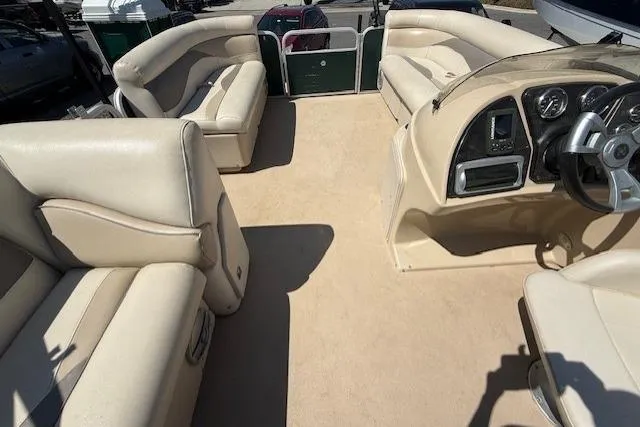 Slide: The Image of Interior of a 2015 Sweetwater 2086 BW pontoon boat with beige seating and steering console. - 8