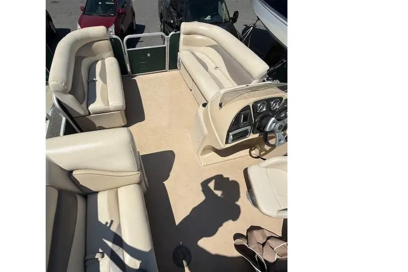 Slide: The Image of 2015 Sweetwater 2086 BW pontoon boat interior with beige seating and steering console. - 9