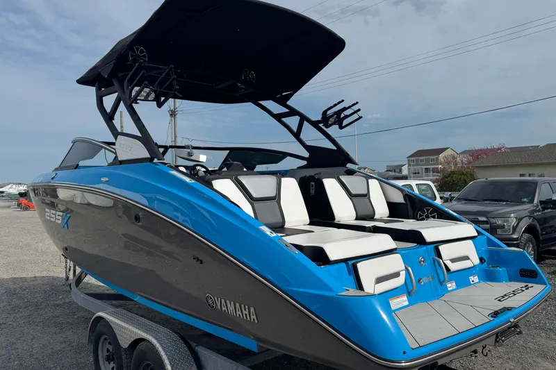 Slide: The Image of 2022 Yamaha Boats 255XD in blue, parked on a trailer, showcasing sleek design. - 5