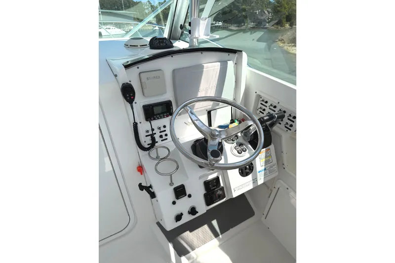 Slide: The Image of 2008 Southport 28 Tournament Express helm with steering wheel and navigation controls. - 12