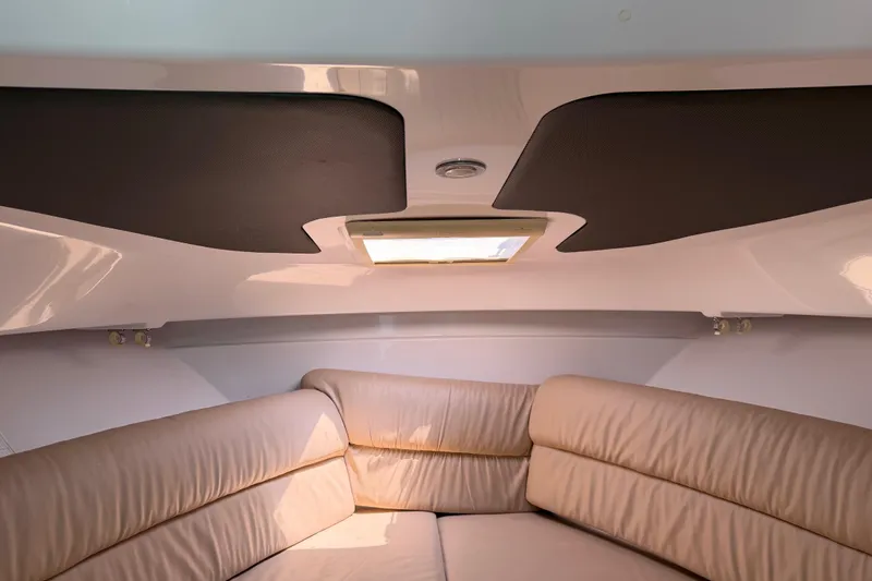 Slide: The Image of Interior cabin of 2008 Southport 28 Tournament Express with beige seating and overhead hatch. - 30