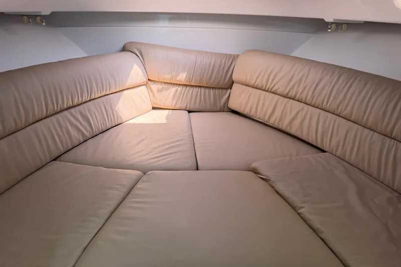 Slide: The Image of 2008 Southport 28 Tournament Express cabin with beige cushioned seating. - 32