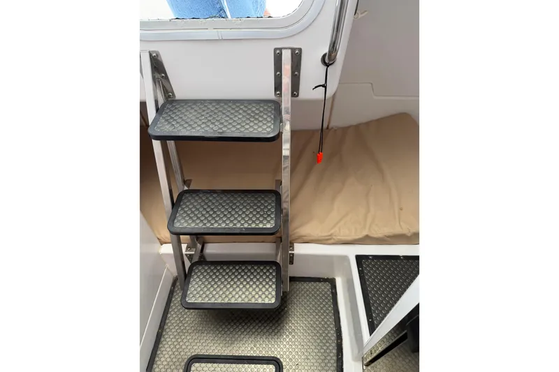 Slide: The Image of Interior view of 2008 Southport 28 Tournament Express boat with metal steps and cushioned seating. - 34
