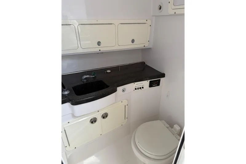 Slide: The Image of 2008 Southport 28 Tournament Express boat bathroom with sink, toilet, and storage cabinets. - 36