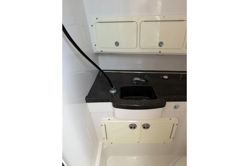 Slide: The Image of Interior view of 2008 Southport 28 Tournament Express boat's compact kitchenette area. - 37