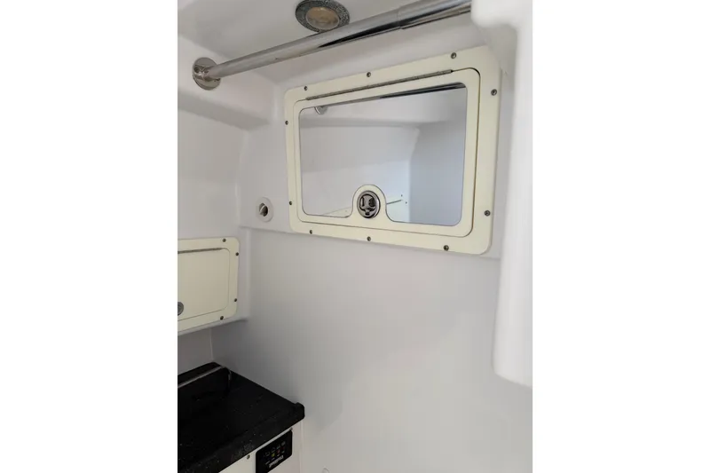 Slide: The Image of 2008 Southport 28 Tournament Express cabin interior with window and storage compartments. - 38