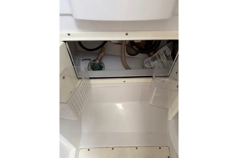 Slide: The Image of Interior compartment of a 2008 Southport 28 Tournament Express boat, showing storage and wiring. - 39