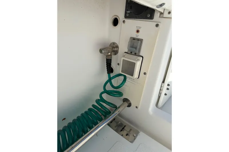 Slide: The Image of 2008 Southport 28 Tournament Express boat utility panel with coiled green hose. - 41