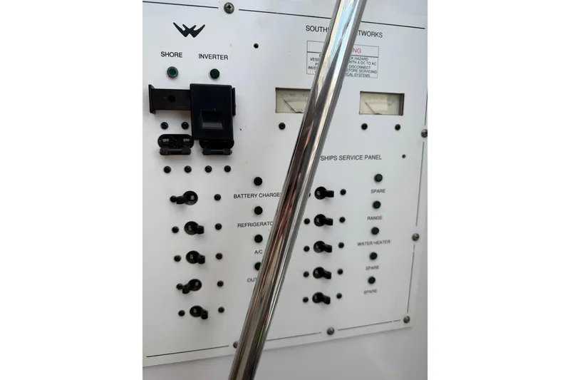 Slide: The Image of Electrical panel of a 2008 Southport 28 Tournament Express boat, featuring switches and meters. - 44