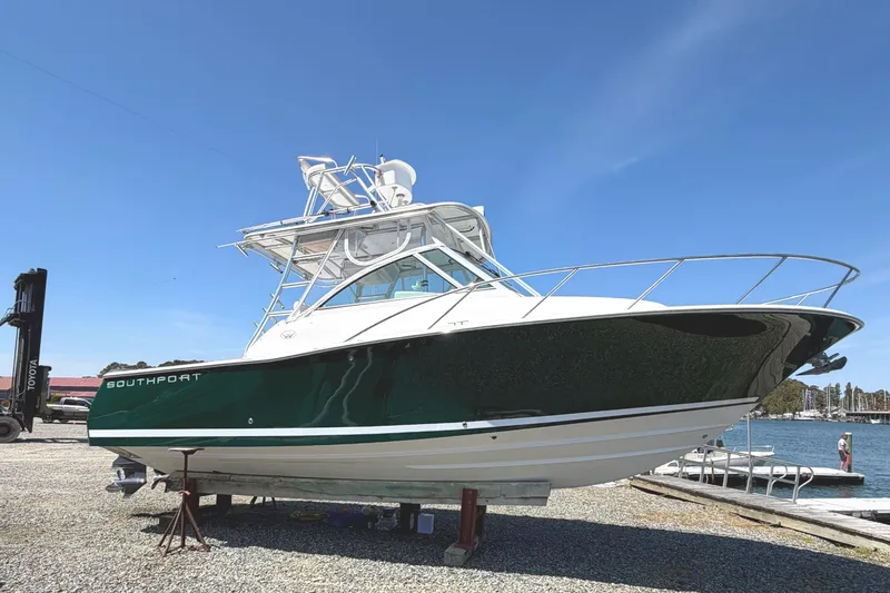 Slide: The Image of 2008 Southport 28 Tournament Express boat on dry dock, green hull, clear sky background. - 5