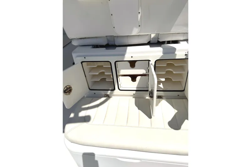 Slide: The Image of Storage compartments on a 2008 Southport 28 Tournament Express boat, featuring open cabinet doors. - 9