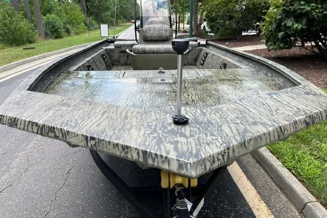 Slide: The Image of 2026 Tracker Grizzly 1860 CC boat with camouflage design on a road. - 9