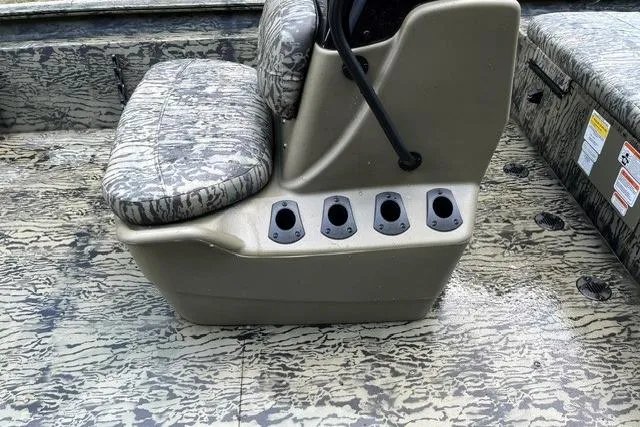 Slide: The Image of 2026 Tracker Grizzly 1860 CC boat interior with camo seating and rod holders. - 8