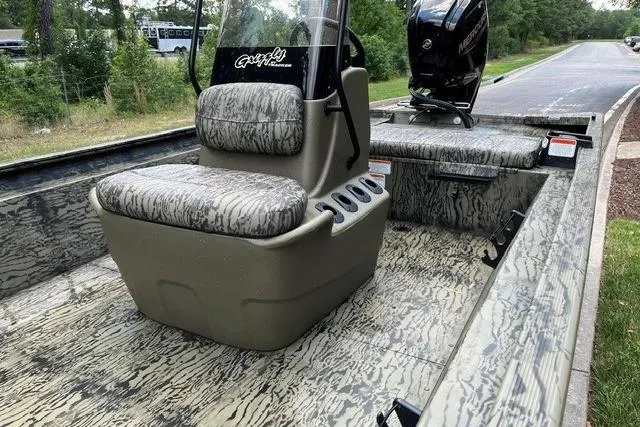 Slide: The Image of 2026 Tracker Grizzly 1860 CC boat interior with camo seating and console. - 5