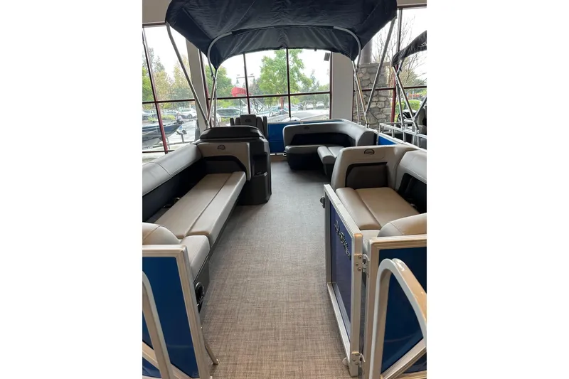 Slide: The Image of 2026 Sun Tracker Party Barge 18 DLX interior with spacious seating and canopy. - 2