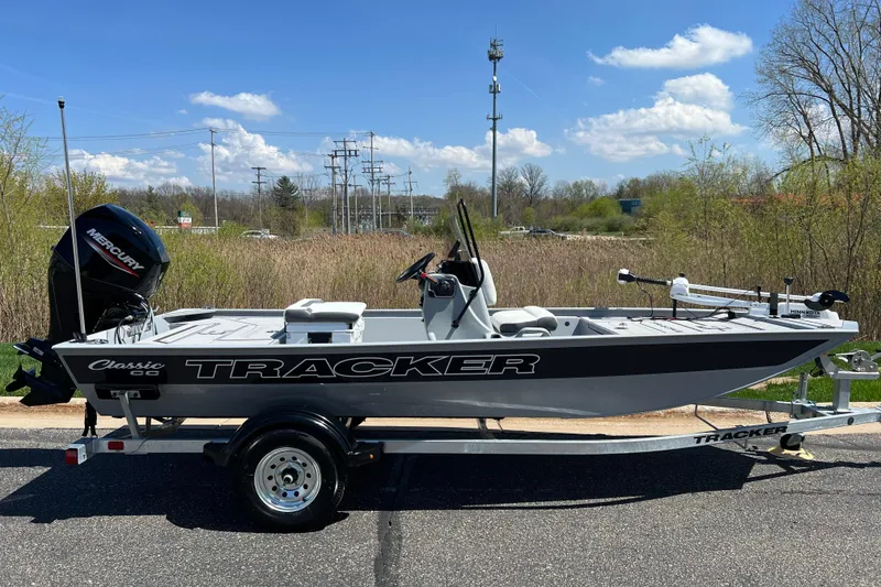 The Image of 2026 Tracker Bass Tracker Classic CC boat on trailer, outdoors under blue sky. - 0