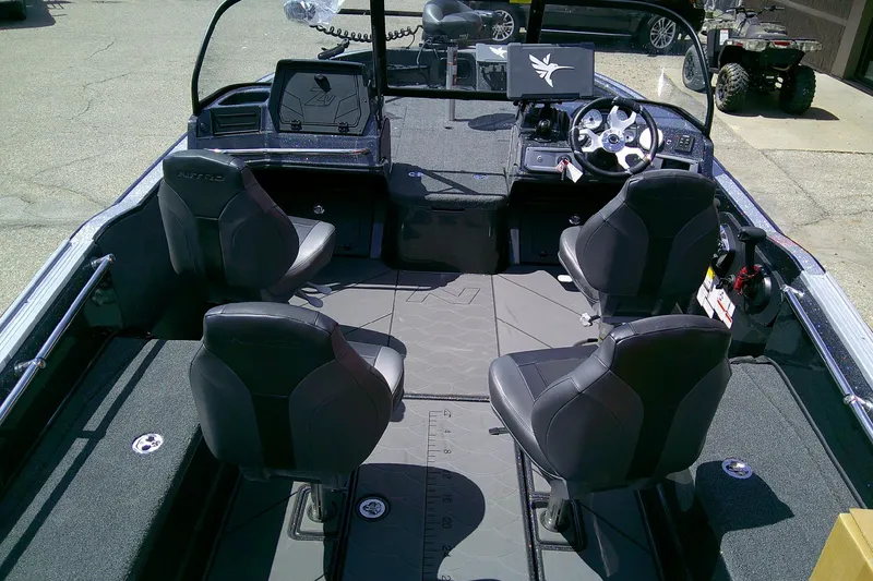 Slide: The Image of Interior of a 2026 Nitro ZV20 boat with four black seats and modern dashboard. - 7