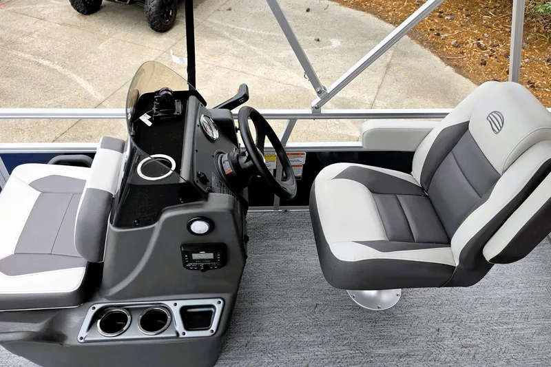 Slide: The Image of 2026 Sun Tracker Bass Buggy 16 XL Select interior with steering console and seating. - 6