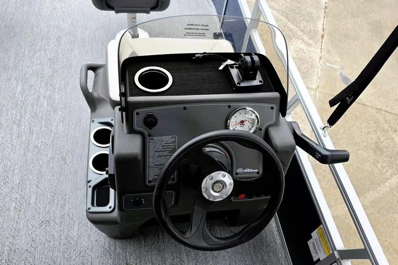 Slide: The Image of 2026 Sun Tracker Bass Buggy 16 XL Select dashboard with steering wheel and cup holders. - 7