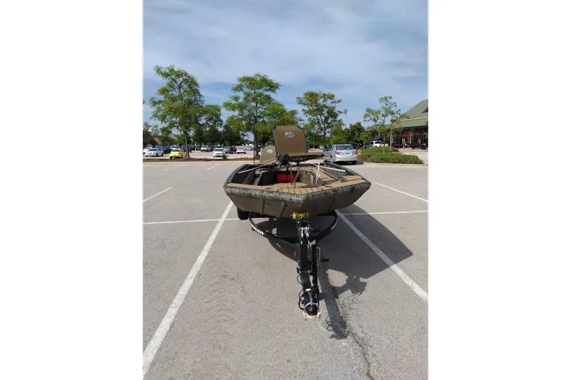 Slide: The Image of 2026 Tracker Grizzly 1756 T Marsh boat parked in a lot, sunny day. - 4