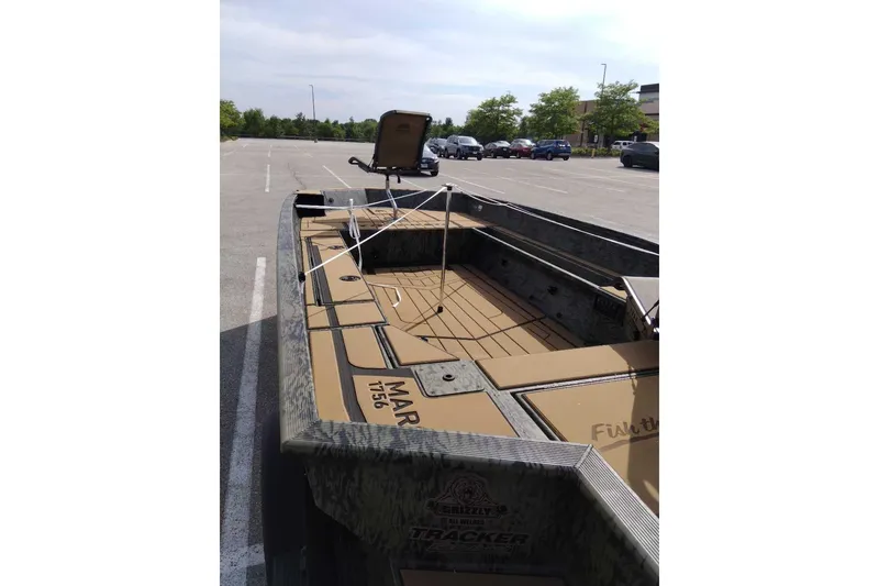 Slide: The Image of 2026 Tracker Grizzly 1756 T Marsh boat in parking lot, interior view. - 2